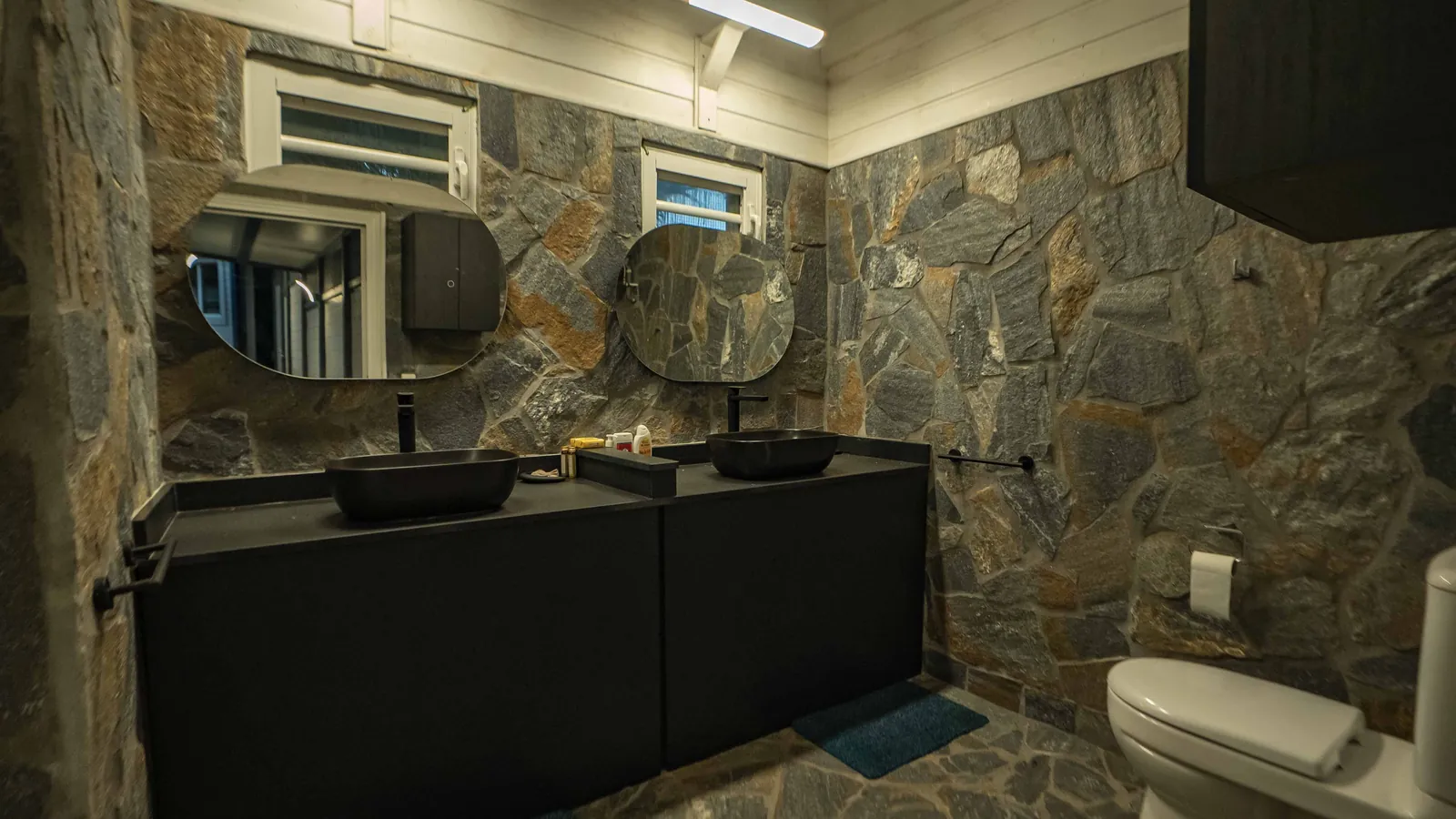 Pavillon Bubble Blue Wave — salle de bain en pierre, double vasque noire